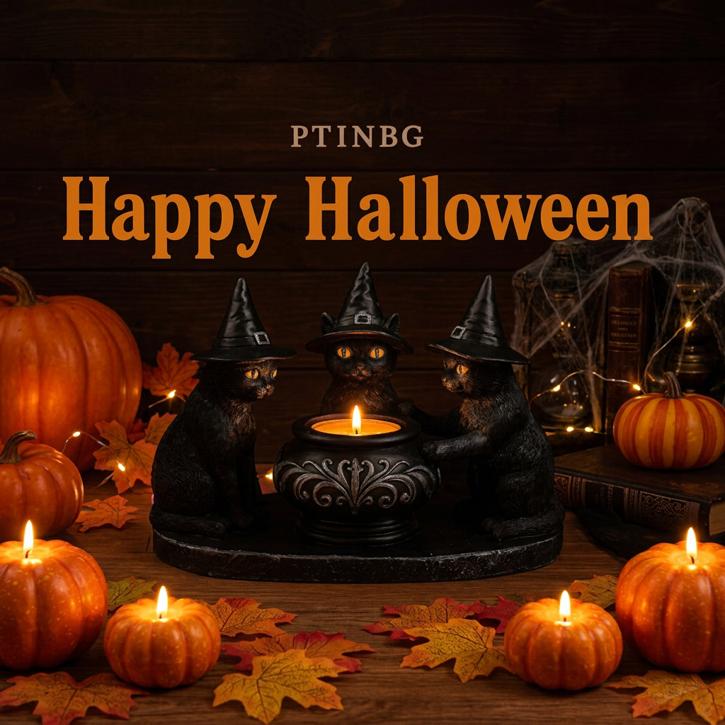 Three black cat figurines wearing witch hats sit around a small lit candle holder on a wooden surface, with pumpkins, autumn leaves, and warm string lights in the background.