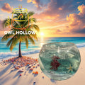 Clear glass fishbowl candle filled with aqua gel wax and decorative fish, seashells, and a starfish against a tropical beach sunset backdrop.