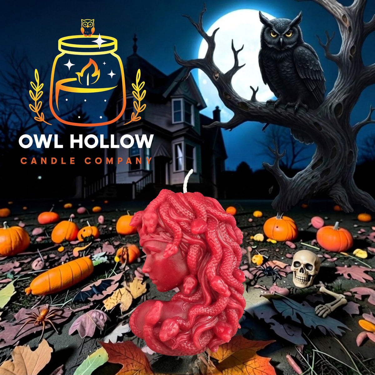 A blood red wax candle shaped like Medusa's head with curly hair stands in a Halloween-themed outdoor scene with pumpkins, autumn leaves, a haunted house, a tree branch, an owl, and a small skeleton. 