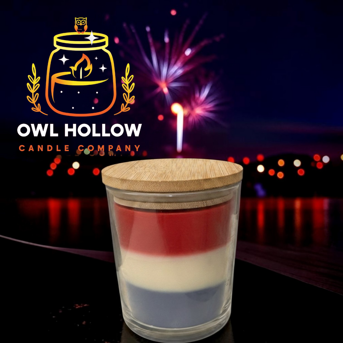 Red, white, and blue layered candle in a clear glass container with a wooden lid, displayed against fireworks with Owl Hollow Candle Company branding.